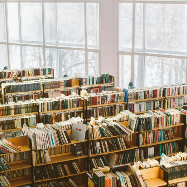Spacious library room with bookshelves under natural daylight for study or research.